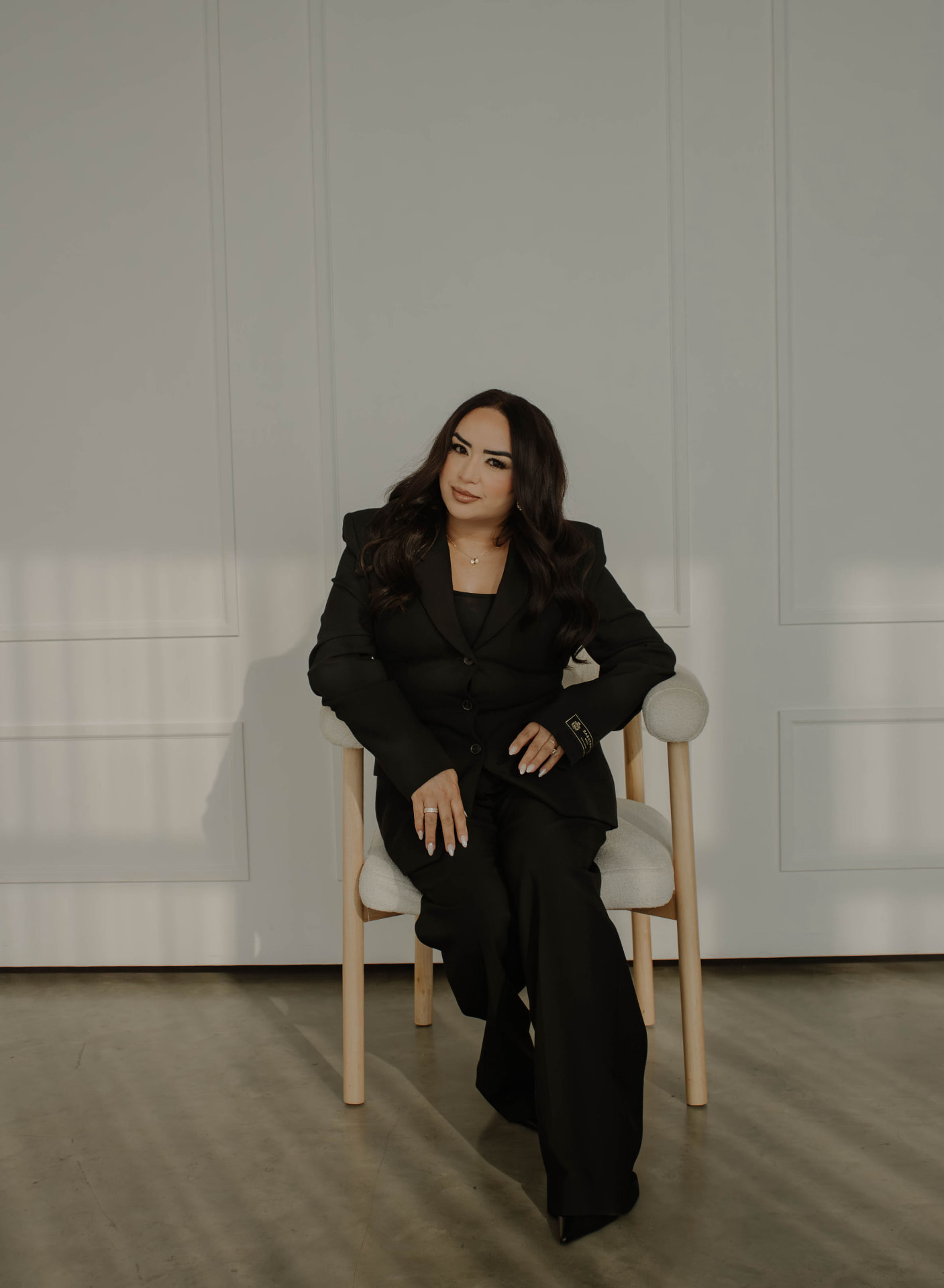 Gagan, founder of Maison Aesthetics, seated in a softly lit studio in Calgary